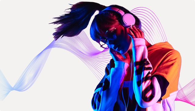 A rainbow colored scene shows a hand holding a shiny disco ball microphone in front of tropical plants with the Spotify premium logo in the corner