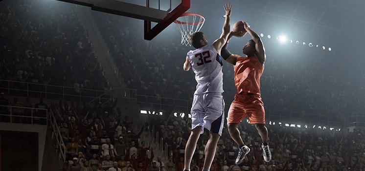 Pro basketball players on basketball court.